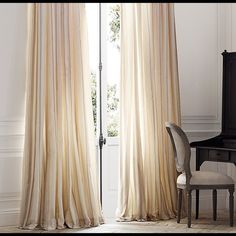 a piano and chair in front of a window