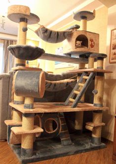 the cat tree is made out of wood and has several scratchings on top of it