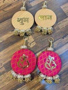 three pairs of earrings with gold and pink designs on the front, one has an ombre