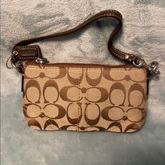 Coach Wristlet With Signature C Design. Khaki And Mahogany. See Pictures For Size. Brown Rectangular Wristlet For Everyday Use, Everyday Brown Rectangular Wristlet, Brown Everyday Rectangular Wristlet, Brown Rectangular Bags With Wrist Strap, Classic Brown Wristlet For Everyday Use, Chic Brown Wristlet For Everyday Use, Trendy Beige Clutch Wristlet, Brown Coach Bag With Wrist Strap, Brown Travel Wristlet With Adjustable Strap