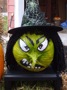 a pumpkin with a witch's face painted on it