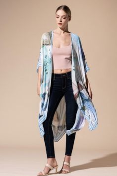 Wrap yourself in elegance with our Watercolor Open Front Kimono! Featuring a delicate and light watercolor effect, this kimono is perfect for everyday wear. The charming stripe border adds a touch of flair to the floral and leaf print, making it suitable for any occasion. One size fits most, making it versatile to layer over jeans, a maxi dress, or even a swimsuit. Crafted from lightweight, flowing fabric, it's the perfect addition to your wardrobe. 100% Viscose Length: 38" Width: 40" One Size F Blue Floral Print Kimono, Blue Floral Print Flowy Kimono, Feminine Floral Print Summer Kimono, Summer Feminine Floral Print Kimono, Flowy Blue Floral Print Kimono, Spring Floral Print Elegant Kimono, Blue V-neck Kimono For Spring, Spring Daywear Wrap Kimono, Elegant Floral Print Spring Kimono