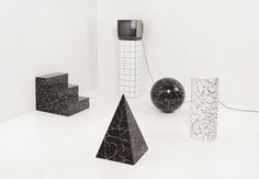 black and white photograph of various objects in an art gallery, including a television set