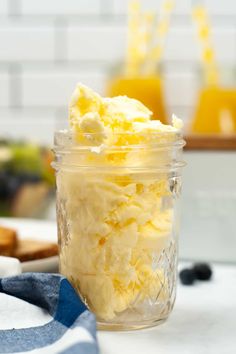 a glass jar filled with food sitting on top of a counter next to a blue and white towel