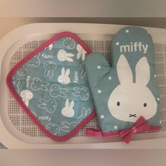 two oven mitts are sitting next to each other on a tray with bunny designs