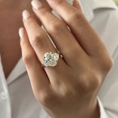 a close up of a person wearing a diamond ring