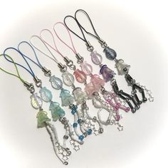 a bunch of different colored lanyards on a white surface with one being a keychain