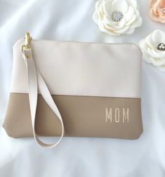 a mother's purse with flowers on the side and a white flower behind it