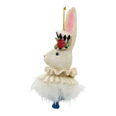 an ornament shaped like a rabbit wearing a hat with feathers on it's head