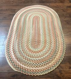 a round rug on the floor in a room with wood floors and hard wood floors