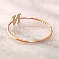 This unique initial letter cut-out is composed of 14K solid gold and beautifully complemented by a durable 14K solid gold band. Initial Letter Dimensions: approximately 5mm (w) x 5mm (h) Band Thickness: approximately 1.25mm Metal Finish: High Shine Polish This design is available in Rose, White and Yellow 14K Gold This item is proudly made in USA and also available in 18K solid gold options upon request. Kindly email info@nanabijoujewelry.com for further assistance with pricing and details. Plea Personalized Initial Ring In White Gold, Personalized Initial Ring In Yellow Gold, 14k Gold Stackable Rings With Initials, Minimalist Initial Rose Gold Ring, Personalized 14k White Gold Initial Ring, Personalized 14k Gold Rings With Initials, White Gold Monogram Ring In 14k, White Gold 14k Monogram Ring, Classic 14k Gold Initial Ring For Personalized Gift