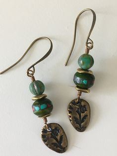 Boho dangle earrings, with green Tibetan Inlay bone beads, small gold spacer beads, and green Czech glass beads. Petite brass TierraCast Flora teardrop charm attached, and antique brass ear wires. The earrings measure approx 53 mm from the top of the ear wire to the bottom. Bone Beads, Hand Made Jewelry, Green Bead, Earrings Dangle, Czech Glass Beads, Ear Wire, Boho Earrings, Spacer Beads, Ear Wires