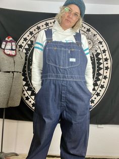 Super dope vintage 1960's/70's overall bibs  Sears tradewear brand  Adjustable straps that have been cut  doesn't really effect much other then the length of strap you're able to utilize.  Soft  worn in denim/cotton darker denim color  Great vintage condition with some normal wear and tear Paint stains on back rear of overalls.  carpenter style overalls  Tag reads size 40w/30 in long  Measurements taken flat are double waist and hips for more accurate sizing  Waist: 21 in  Hips: 21.5 in  Inseam: 28 in  Length: 53 in long  all sales are final  Thanks for checking out Cereal Vintage Thrift  Recycle Reuse Recreate Retro Bib Front Overalls With Pockets, Retro Denim Blue Overalls With Pockets, Vintage Denim Blue Overalls With Pockets, Retro Medium Wash Cotton Overalls, Vintage Medium Wash Overalls With Pockets, Vintage Denim Blue Overalls, Retro Overalls With Pockets, Vintage Dark Wash Overalls, Vintage Denim Bib Front Shortalls