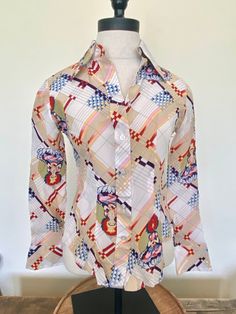 "70s White Tara unique print blouse White Tara is the Bodhisattva of compassionate activity This rare and pristine blouse is in excellent vintage condition Looks like it has never been worn. White buttons Two button cuffs Brand - Jeune Belles Tag size 7/8, most likely a xsmall/small, go by the measurements 100% Rayon FREE SHIPPING Measurements laying flat: Bust - 16\" Sleeve - 21\" Length - 21.5\"" Fitted Multicolor Graphic Print Blouse, White Tops With Unique Print, Fitted White Top With Abstract Print, White Fitted Top With Abstract Print, Vintage Long Sleeve Printed Shirt, Fitted Multicolor Tops With Retro Print, Fitted Multicolor Retro Print Tops, Retro Multicolor Top With Unique Print, White Fitted Vintage Blouse