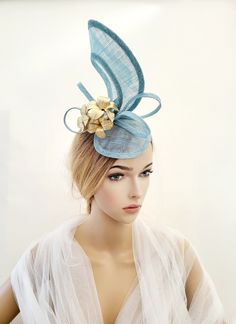 "Presenting a beautiful baby blue sinamay straw percher hat fascinator with gold leather leaf detail.  Attached by your choice of colour satin ribbon wrapped headband or millinery elastic. If you would like the design customising at all, or an alternate colourway please get in touch with me and I will be delighted to help.  All our hats are handmade in the UK using traditional millinery techniques. These items are made to order (unless otherwise specified) and take hours of work, please refrain Handmade Gold Hat For Kentucky Derby, Gold Spring Fascinator For Church, Handmade Gold Hats For Party, Adjustable Gold Mini Hats For Spring, Gold Spring Church Fascinator, Gold Hair Accessories For Spring Wedding, Handmade Gold Party Hat, Adjustable Light Blue Fascinator For Royal Ascot, Gold Fascinator Hat For Races