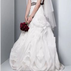 a woman in a wedding dress holding a bouquet