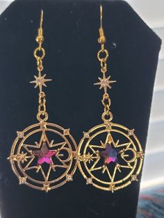 Handmade Earrings based (roughly) on schools of magic from D&D! Fantasy Earing Design, Fantasy Accessories Art, Fantasy Gold Earrings For Gift, Magical Gold Earrings For Gift, Fantasy Earrings Magic, Gold Fantasy Handmade Earrings, Dangling Star Earrings, Regal Earrings, Magic Reference