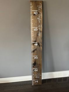 a tall wooden ruler with numbers on it