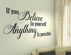 a living room with a couch and wall decal that says, if you believe in yourself anything is possible