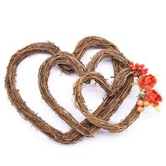 two heart shaped wreaths made out of twigs and flowers