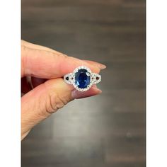 This gorgeous 18k white gold ring is set with a natural blue sapphire weighing 3.02 ct. It is surrounded with 66 round diamonds with a carat weight of 0.62. The diamonds boast a color of G/H and is SI1-SI2 in clarity. A beautiful ring to add to any jeweler's collection. Exquisite Sapphire Diamond Ring With Vvs Clarity, Dazzling Sapphire Ring With Diamond, Exquisite Sapphire Diamond Ring Gia Certified, Exquisite Gia Certified Sapphire Diamond Ring, Dazzling Sapphire Diamond Ring, Oval Sapphire Ring In Diamond White, Dazzling Gia Certified Sapphire Diamond Ring, 14k White Gold Sapphire Diamond Ring Vvs Clarity, Exquisite Sapphire Ring With Cubic Zirconia Stones