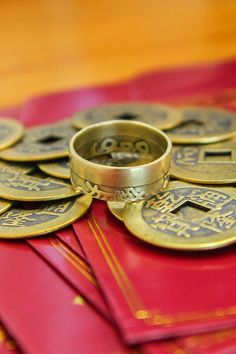 a stack of chinese coins sitting on top of red envelopes