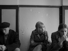 three people sitting on the ground in front of mirrors