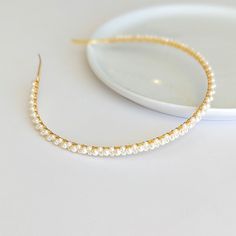 Add a touch of elegance to your wedding hairstyle with our dainty pearl headband. This exquisite bridal hair accessory is perfect for any bride seeking a chic and sophisticated look on her special day.  DETAILS: - Each item is made to order and delicately handcrafted - 3mm wide metal headband (gold or silver) - One size fits most - Wrapped with silver or gold plated jewelry wire - High quality glass pearls (white or ivory) - Easy to wear and will complement any bridal hairstyle - Excellent styli Bride Short Hair, White Pearl Headband, Short Hair Accessories, Short Hair Bride, Headband Gold, Pearl Bridal Headband, Simple Headbands, Minimalist Bride, Bride Headband