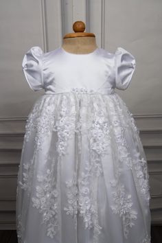 Christening gown for baby girls Gown length: 31 inches Color: white Embroidery: Beads and 3d flowers Fabric: Lace and Satin Underlay - 2 layers, satin and cotton Weight - Lightweight Sleeve - Puff sleeves Features - Floral accents on the waistline, zip closure at the back Please note: Dry clean only. Caremour promises - 1) Stress free shipping guarantee - Free expedited international shipping - Offer applicable Worldwide. Typical shipping time: 3-7 days 2) No surprise guarantee - Rest assured th Elegant Lace First Communion Dress With Floral Applique, White Princess Dress With Floral Applique For First Communion, White Lace First Communion Dress With Floral Applique, White Organza Princess Dress For Baptism, White Floral Applique First Communion Dress, White Lace Baptism Dress With Floral Applique, White Floral Embroidered Dress For Baptism, Elegant Floral Applique Dress For Baptism, Elegant Princess Dress With Floral Applique For First Communion