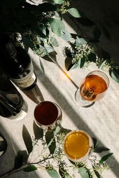 three glasses filled with different types of drinks