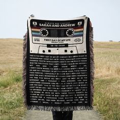 a person walking down a path holding a blanket