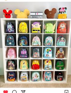 a white book shelf filled with lots of backpacks