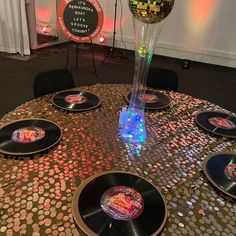 a table with disco balls and plates on it