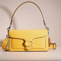 This Beautiful Tabby In Trendy Color Canary. A Modern Take On An Archival 1970s Coach Design, Our Structured Tabby Shoulder Bag Is Crafted Of Polished Pebble Leather. Finished With Our Tonal Leather-Covered Signature Hardware For An Iconic Touch, The Compact 26 Features Two Detachable Straps To Carry By Hand, Style As A Short Shoulder Bag Or Wear Crossbody. Authentic From Retail Coach. No Returns. Feel Confident Shopping From My Collection. Maybe Sold Out By Popular Demand. Stay Tune For More Fr Classic Yellow Bag With Removable Pouch, Classic Yellow Bags With Removable Pouch, Classic Yellow Shoulder Bag With Gold-tone Hardware, Retro Yellow Satchel Bag, Vintage Yellow Bag With Removable Pouch, Classic Yellow Coach Bag, Vintage Yellow Crossbody Bag, Retro Yellow Shoulder Bag With Adjustable Strap, Yellow Rectangular Shoulder Bag With Detachable Strap