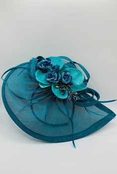 Stunning Orchid and Gemstone Lake Blue Turquoise Teal Wedding Fascinator Hat A beautiful lake blue turquoise teal fascinator hat with  feathers, gemstones and orchids  Size 30.5 x 23cm head band or hair clip attachment  Perfect mother-of-the-bride wedding day accessory.   Elegant addition for those on the day essentials. matching Clutch Bag available Blue Mini Hats With Handmade Flowers And Adjustable Fit, Adjustable Blue Mini Hats With Handmade Flowers, Elegant Turquoise Fascinator For Royal Ascot, Elegant Turquoise Fascinator For Races, Elegant Turquoise Fascinator For Kentucky Derby, Elegant Turquoise Fascinator For Wedding, Turquoise Headpiece For Summer Wedding, Turquoise Headpieces For Summer Weddings, Turquoise Summer Wedding Headpiece