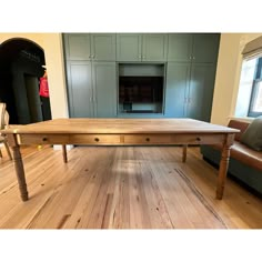 a large wooden table sitting on top of a hard wood floor