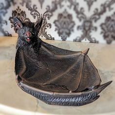 a statue of a bat sitting on top of a table