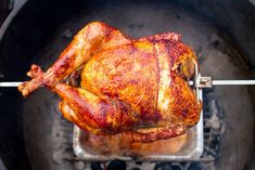 a roasted chicken is being cooked on the grill