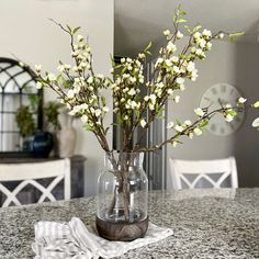 a vase filled with white flowers on top of a table