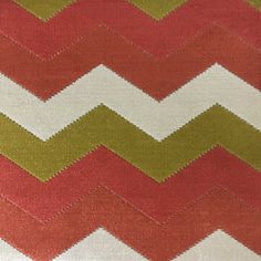 an orange, green and white zigzag pattern on fabric