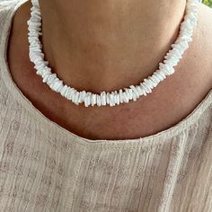 "This unique necklace is made with 10mm pure white artisan grade Queen scallop shells from the North Atlantic. The disc cut of the shell is organic, wavy and asymmetrical. The beads are tumbled to smooth the edges and give the beads a fine satin finish. The appearance of the finished piece is carefree, light and airy. Great necklace to wear on a beautiful summer day. - Not dyed, treated or color enhanced. 100% natural. - Photos taken outside in natural lighting and in a light box.  - No filters White Shell Necklace As Gift, Adjustable White Beaded Necklace With Natural Stones, Adjustable Single Strand White Jewelry, White Adjustable Single Strand Jewelry, Adjustable White Single Strand Jewelry, Elegant White Shell Necklace With Natural Stones, Adjustable White Necklace With Gemstone Beads, Adjustable White Gemstone Bead Necklaces, White Shell Jewelry Gift