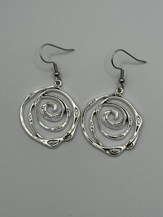 Silver Swirl Geometric Earrings,  Swirls Dangle Drop Earrings, Swirly Jewelry, Spiral Earrings,Trendy Earrings, Geometric Spiral,Gift for Her, Birthday Gift, appreciation gift, Just because Gift, Gift for her, Mother's Day gift.  Free shipping in the USA I do not ship invoices unless requested. Feel free to message me if you have any questions. I would be happy to help. Other Spiral Jewelry: https://www.etsy.com/listing/1268065642/gold-swirls-dangle-drop-earrings-swirly?click_key=9bc01de610b1d996c38d2a51442d7993b71d3658%3A1268065642&click_sum=074bc59b&ref=shop_home_active_102&frs=1&crt=1 Swirl Earrings Spirals, Swirl-shaped Earrings With Ear Wire, Hypoallergenic Spiral Metal Earrings, Swirl Shaped Nickel-free Hoop Earrings As Gift, Nickel-free Swirl Hoop Earrings Gift, Swirl Hoop Earrings Nickel Free Gift, Swirl Shaped Metal Earrings As Gift, Swirl Shaped Metal Earrings For Gift, Adjustable Spiral Nickel-free Earrings