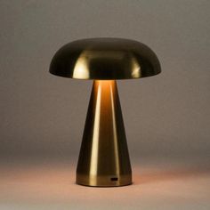 a gold mushroom lamp sitting on top of a table