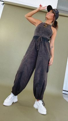 The Corrie Cargo Pant Jumpsuit is a chic and versatile outfit perfect for all your adventures. This jumpsuit is ideal for everything from weekend brunches to outdoor gatherings. Pair it with sneakers for a casual look, a must-have piece for your summer wardrobe. Ribbed knit tank jumpsuit Side zipper with eyelet closure in tank, easy to take on and off! Elastic waistband Adjustable waist ties Functional pockets Tie around the ankle, allowing you to create a jogger-style bottom Self=100% cotton Li Casual Drawstring Jumpsuits And Rompers For Loungewear, Casual Jumpsuits And Rompers With Drawstring For Loungewear, Casual Overall Jumpsuits And Rompers For Loungewear, Casual Overalls With Side Pockets, Spring Athleisure Overalls Jumpsuit, Spring Athleisure Jumpsuits And Rompers For Leisure, Cargo Style Overall Jumpsuit For Summer, Relaxed Fit Casual Overalls For Loungewear, Casual Relaxed Fit Overalls For Loungewear