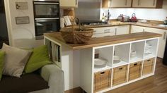 a kitchen with a couch and some baskets on the counter