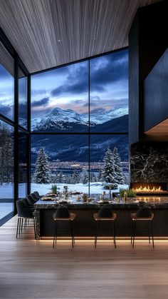 a dining room with a large window overlooking the mountains