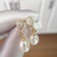 These stunning earrings feature lustrous oval pearls, accented with sparkling water drop-shaped zircons. The 18K gold plating adds a touch of modernity and makes them long-lasting, non-tarnishing for years! Pearl Type: Freshwater Pearls Pearl Quality: [Shape]: Oval [Size]: 8-9mm [Blemish]: None [Luster]: High Material: 18k Gold Plated Brass Note: Every pearl is unique. Items may vary from the pictures. Luxury Oval Pearl Drop Earrings, Oval Pearl Charm Earrings For Anniversary, Elegant Gold Pear-shaped Bridal Earrings, Elegant Gold Plated Teardrop Earrings For Party, Elegant Gold Plated Teardrop Earrings For Formal Occasions, Elegant Oval Bridal Earrings For Anniversary, Luxury Teardrop Pearl Drop Earrings, Luxury Gold Oval Pearl Earrings, Elegant Oval Pearl Charm Earrings