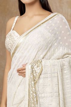 Ivory saree with all over floral chikankari work and sequin embroidered border. Paired with a padded blouse with all over sequin embroidery. - Aza Fashions Festive White Pre-draped Saree With Intricate Embroidery, White Anarkali Pre-draped Saree With Intricate Embroidery, Wedding Blouse With Chikankari Embroidery For Transitional Season, White Embroidered Pre-draped Saree For Navratri, Transitional White Pre-draped Saree With Traditional Drape, Designer White Blouse Piece With Chikankari Embroidery, White Pre-draped Saree With Intricate Embroidery For Festive Occasions, White Anarkali Blouse Piece With Intricate Embroidery, White Georgette Blouse Piece For Navratri