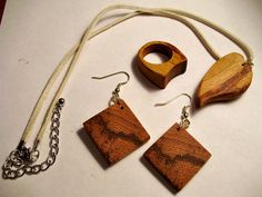 This is a beautiful jewelry set consisting of a necklace, pendant, earrings and a ring size 7. They were constructed out of exotic Marblewood wood. You can enjoy the set for yourself, or make it a wonderful gift set! Handmade Wooden Pendant Jewelry, Artisan Wooden Jewelry As A Gift, Artisan Wood Jewelry Gift, Unique Mahogany Jewelry For Gift, Mahogany Handmade Jewelry For Gift, Handmade Mahogany Jewelry For Gift, Handmade Mahogany Jewelry Gift, Nature-inspired Wooden Jewelry Gift, Natural Colored Jewelry Set With Matching Earrings For Gifts