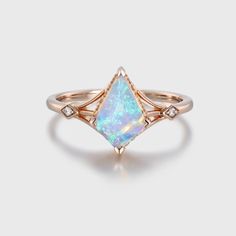 Kite Cut Opal and Diamond Bridal Ring in the warm embrace of rose gold—a mesmerizing fusion of opulence, elegance, and natural beauty. 14k Rose Gold Gemstone Wedding Jewelry, Rose Gold Marquise Gemstone Wedding Ring, Luxury Rose Gold Opal Gemstone Ring, Fine Jewelry Rose Gold Opal Rings, Fine Jewelry Opal Rings In Rose Gold, Rose Gold Opal Ring In Fine Jewelry Style, Elegant Opal Ring With Diamond In Rose Gold, Elegant Emerald Cut Opal Ring, Elegant Rose Gold Opal Ring With Diamond